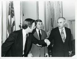 ["Black and white photograph print of Brock Adams, Robert Strauss, and another man at the Democratic leadership conference."]