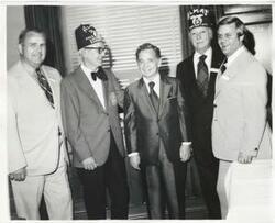 ["Black and white photograph print of Carl Albert standing with members of the Capitol Hill Shrine Club."]