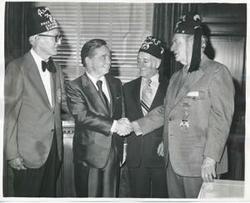 ["Black and white photograph print of Carl Albert standing with members of the Capitol Hill Shrine Club."]