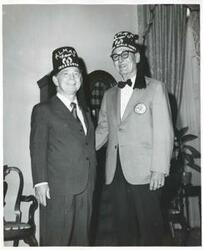 ["Black and white photograph print of Carl Albert standing with members of the Capitol Hill Shrine Club."]