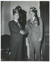 ["Black and white photograph print of Carl Albert standing with members of the Capitol Hill Shrine Club."]