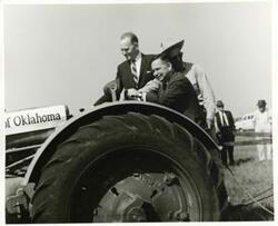 ["Black and white photograph print of Carl Albert and another man seated on a tractor at the Senior Citizens Housing groundbreaking ceremony. Oklahoma City. September 21, 1963"]