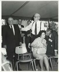 ["Black and white photograph print of Lyndon B. Johnson, Lady Bird Johnson, Sam Rayburn, and Robert S. Kerr at a party commemorating the publication of Kerr's book, Land, Wood and Water. August 1960"]