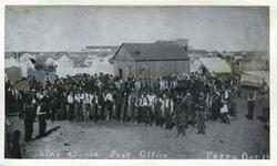 ["Black and white photograph print of a line at the post office. Perry, Oklahoma."]