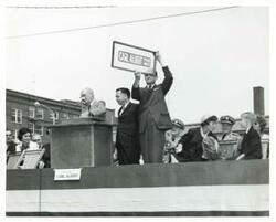 ["Black and white photograph print of Carl Albert at the dedication of the Carl Albert Parkway (McAlester, Oklahoma). Mary Albert and son, David Albert, are to Carl Albert's left."]