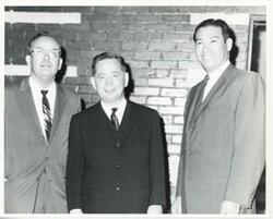 ["Black and white photograph print of Carl Albert with unidentified people."]