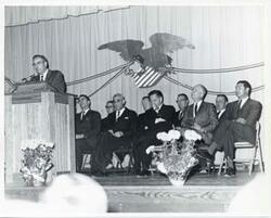 ["Black and white photograph print of Carl Albert with unidentified people."]