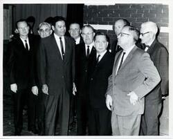 ["Black and white photograph print of Carl Albert with unidentified people."]