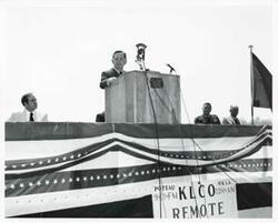 ["Black and white photograph print of Carl Albert speaking at the Port Carl Albert dedication. Ed Edmondson is seated on the left. May 27, 1972"]