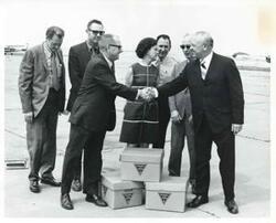 ["Black and white photograph print of presentation of surplus aviation equipment to Aviation Department of Southeastern State College."]