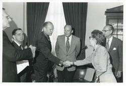 ["Black and white photograph print of presentation of $80,000 to Carl Albert for murals in Capitol. Fred Swengel and Gerald R. Ford are also present."]