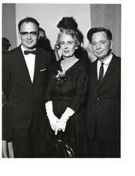 ["Black and white photograph print of Carl Albert, Marcus Cohn, and an unidentified woman."]