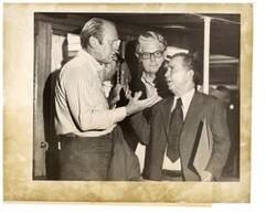 ["Black and white photograph print of Gerald R. Ford talking with House Speaker Carl Albert and John Anderson at the end of a Potomac cruise aboard the presidential yacht Sequoia. July 23, 1974."]