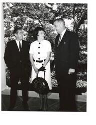["Black and White photograph of Senator Fred Harris of Oklahoma, with his wife, and President Lyndon B. Johnson"]
