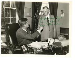 ["Black and White photograph of John F. Kennedy handing Michael J. Kirwan the pen with which he signed the National Aquarium Bill.  Photograph signed by Michael Kirwan (Representative of Ohio) and directed Carl Albert. October 9, 1962."]