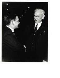 ["Black and White photograph of Carl Albert shaking hands with John W. McCormack."]
