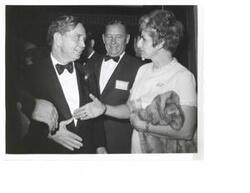 ["Black and White photograph of Carl Albert and Lil Naifeh at the Carl Albert appreciation dinner. Chris Murphy looks on."]