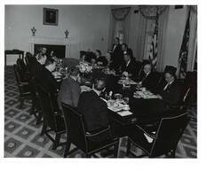 ["Black and White photograph of a breakfast meeting in the White House. Those present include: Lyndon B. Johnson, Hubert Humphrey, John W. McCormack, Carl Albert, Hale Boggs, Carl Hayden, Lawrence F. O'Brien and Mike Mansfield."]