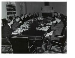 ["Black and White photograph of a breakfast meeting in the White House. Those present include: Lyndon B. Johnson, Hubert Humphrey, John W. McCormack, Carl Albert, Hale Boggs, Carl Hayden, Lawrence F. O'Brien and Mike Mansfield."]