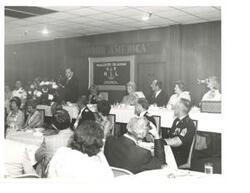 ["Black and white photograph of Carl Albert giving a speech at the United States Naval League Council in McAlester, Oklahoma on Armed Forces Day 1976."]