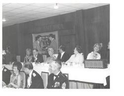 ["Black and white photograph of Carl Albert giving a speech at the United States Naval League Council in McAlester, Oklahoma on Armed Forces Day 1976."]