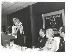["Black and white photograph of Carl Albert giving a speech at the United States Naval League Council in McAlester, Oklahoma on Armed Forces Day 1976."]