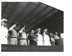 ["Black and white photograph of Carl Albert and military officers on a speaker's platform on Armed Forces Day. McAlester, Oklahoma. May 15, 1976"]