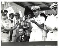 ["Black and white photograph of Carl Albert with others on a speaker's platform on Armed Forces Day in McAlester, Oklahoma. May 15, 1976"]