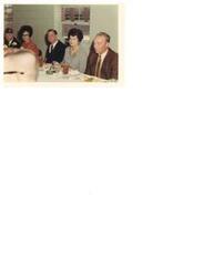 ["Color photograph of Carl Albert at a meal attached to a Veterans' event in Hugo, Oklahoma. 1970. Carl is sitting with two unidentified women and two unidentified men."]