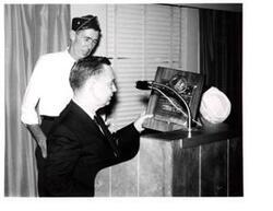 ["Black and white photograph of Carl Albert being presented a Distinguished Service Citation plaque by the DAV."]