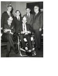 ["Black and white photograph of Carl Albert with some Disabled American Veteran unidentified members.  Man seated on the left (foreground) is D.A.V. Representative Lambert Barkman."]