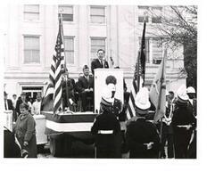 ["Black and white photograph of Carl Albert speaking at an outdoor American Legion event."]