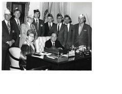 ["Black and white photograph of Carl Albert with a DAV group in the Speaker's office. Second from left is DAV Representative  Harold Goodwin, Third from left is DAV Representative  Lambert Barkman, and Fourth from left is DAV Representative  Paul Freeman."]