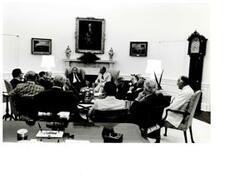 ["Black and white photograph of bipartisan leadership meeting at the White House in July 1975 (in president's office). Present are Carl Albert, Robert C. Byrd, Gerald R. Ford, Mike Mansfield, John McFall, Thomas P. O'Neill, John Rhodes, and Hugh Scott."]