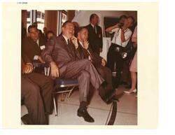 ["Color photograph of Fred Harris, Hubert H. Humphrey, and Carl Albert at the Manned Spacecraft Center, Houston, Texas July 13, 1965"]