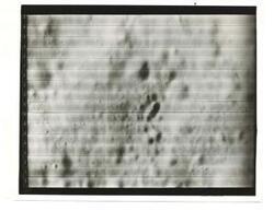 ["Black and white photograph of Moon taken by Orbiter I. August 18,1966."]