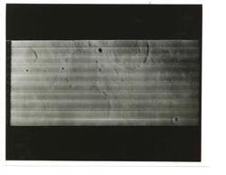 ["Black and white photograph of Moon taken by Orbiter I. August 18,1966."]