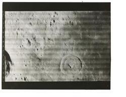 ["Black and white photograph of Moon taken by Orbiter I. August 18,1966."]