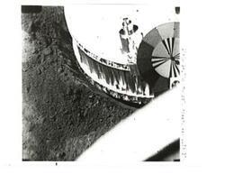 ["Black and white photograph of Moon, with section of Surveyor I in frame, taken by Surveyor I. June 1966"]