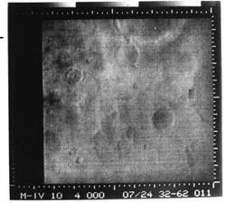 ["Black and white photograph of Mars by Mariner IV. July 14, 1967"]