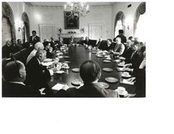 ["Black and white photograph of James Schlesinger, John McFall, James O. Eastland, Carl Albert, Gerald R. Ford, Mike Mansfield, Hugh Scott, John Rhodes, Peter Rodino, and others at the White House Bipartisan meeting. September 16, 1974"]