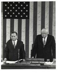 ["Black and white photograph of Carl Albert standing with an unidentified man."]