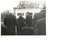 ["Black and white photograph of Richard M. Nixon shaking hands with a man at his 2nd term presidential inauguration. January 20, 1973"]