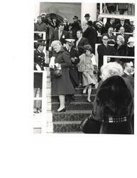 ["Black and white photograph of a military officer escorting Mary Albert down some stairs at President Nixon's 2nd term inauguration. January 20, 1973"]