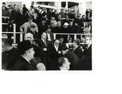 ["Black and white photograph of a large group of people in the background of Richard M. Nixon's 2nd term presidential inauguration."]