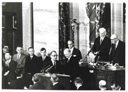 ["Black and white photograph of a joint session of Congress. John W. McCormack, Carl Hayden, and Carl Albert are shown."]