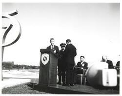 ["Black and white photograph of Astronaut Memorial Dedication Ceremonies. Col. Elmer Richardson receives medallion for Gen. Huston. November 10, 1964"]