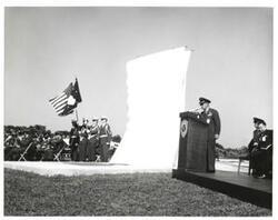 ["Black and white photograph of Astronaut Memorial Dedication Ceremonies. Col. Elmer Richardson opens ceremony. November 10, 1964.  Carl Albert is seated at left in photograph"]