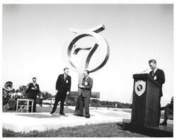 ["Black and white photograph of Astronaut Memorial Dedication Ceremonies. Dr. Kurt Debus receives medallion from Roger Lewis. November 10, 1964"]