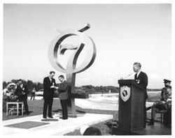["Black and white photograph of Astronaut Memorial Dedication Ceremonies. Astronaut Virgil \"Gus\" Grissom receiving gold medallion from Roger Lewis. November 10, 1964"]